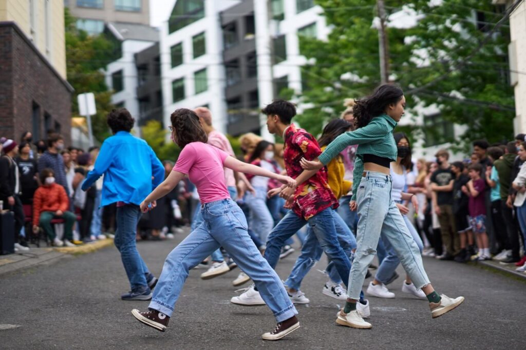 High school students perform a dance routine during the school festival.